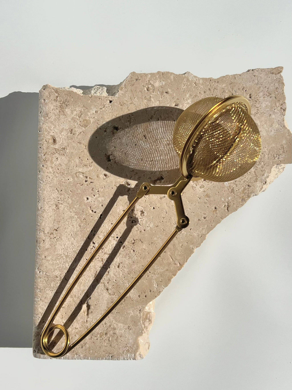 Gold mesh tea infuser.