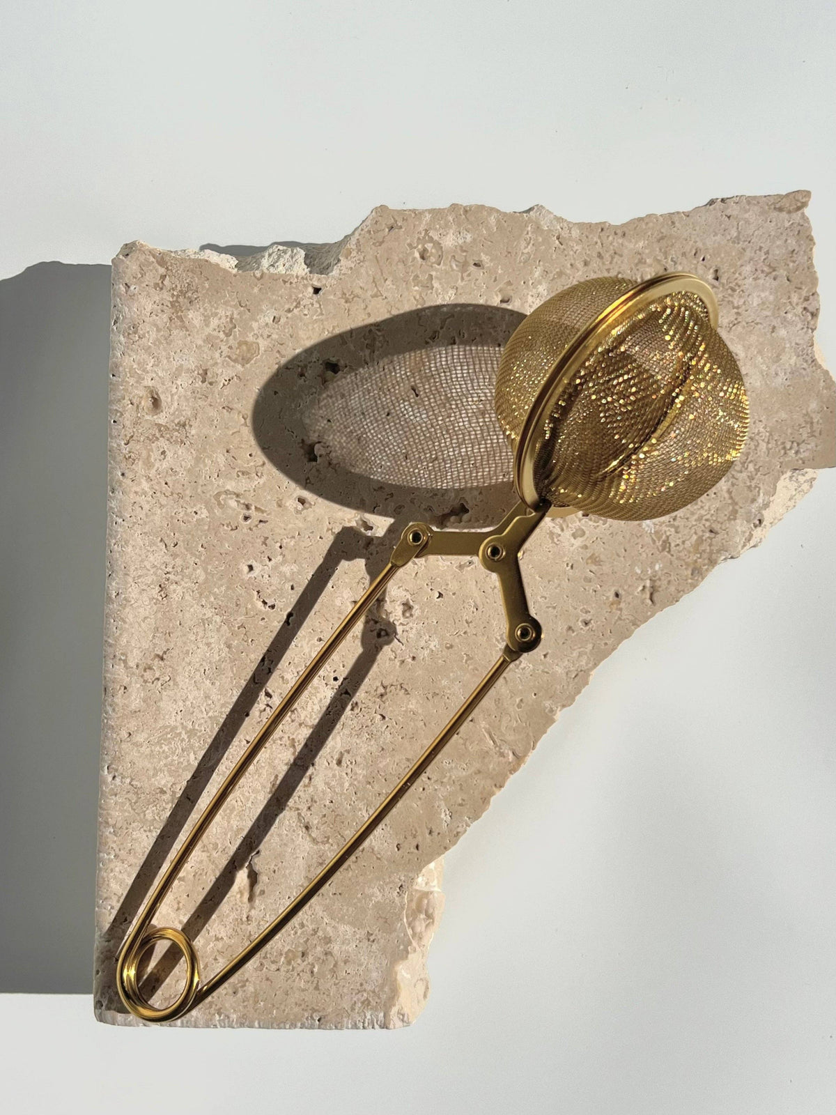 Gold mesh tea infuser.