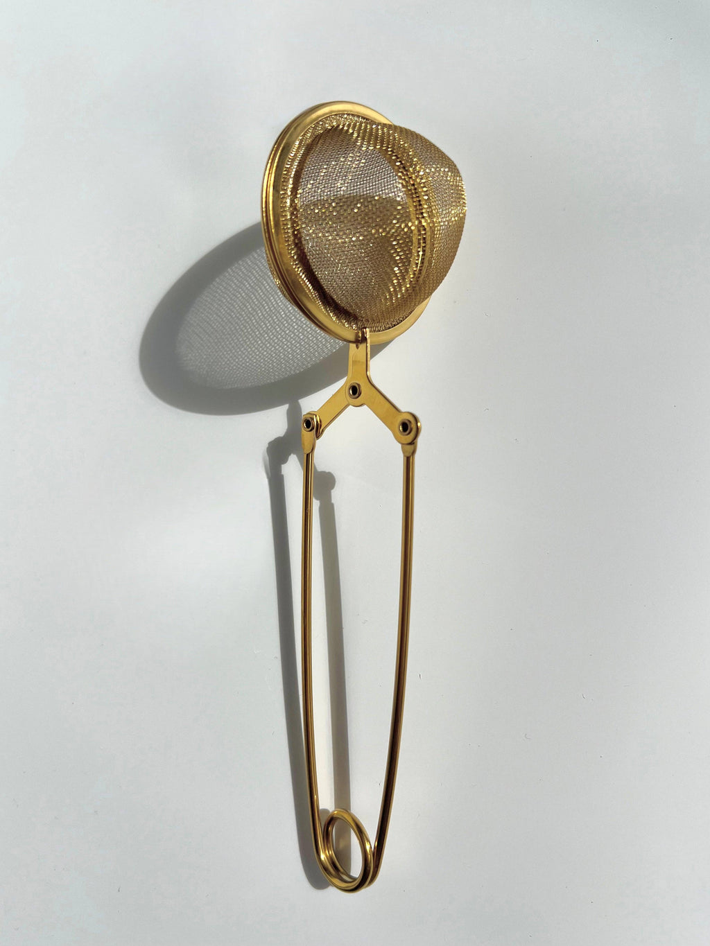 Gold mesh tea infuser.