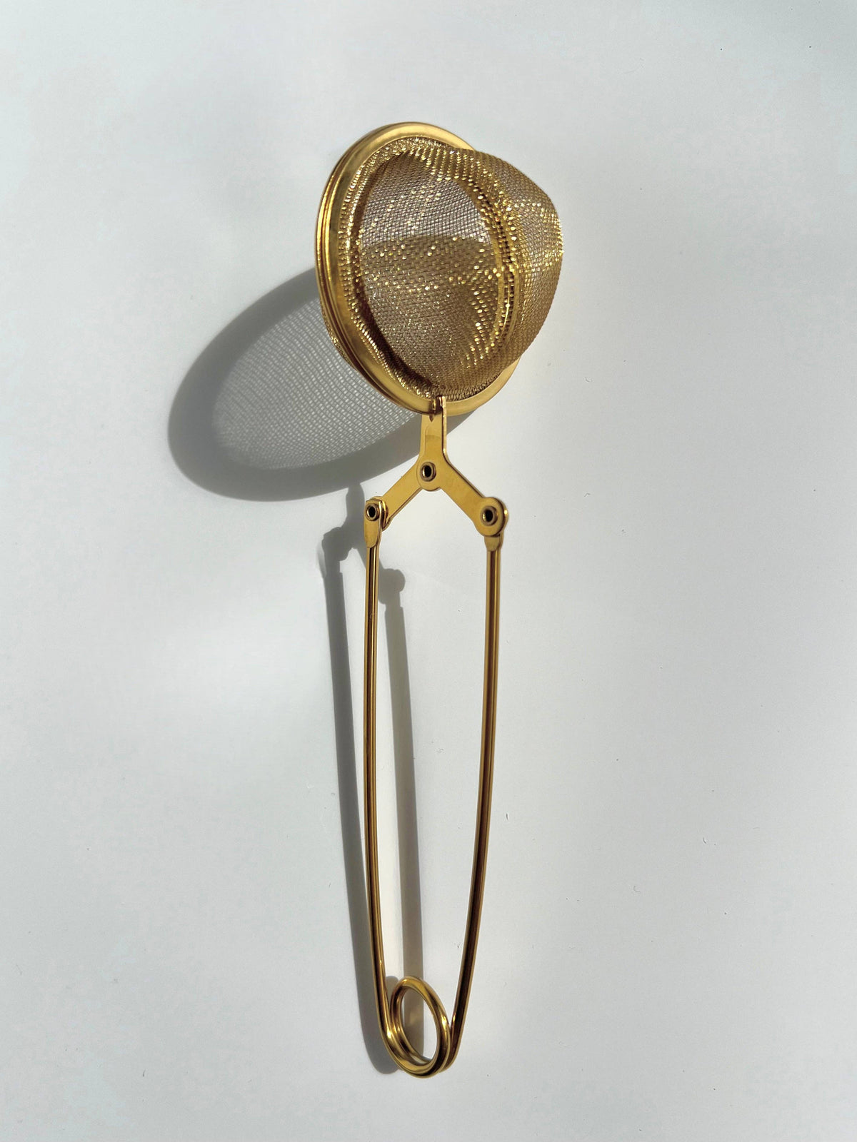 Gold mesh tea infuser.