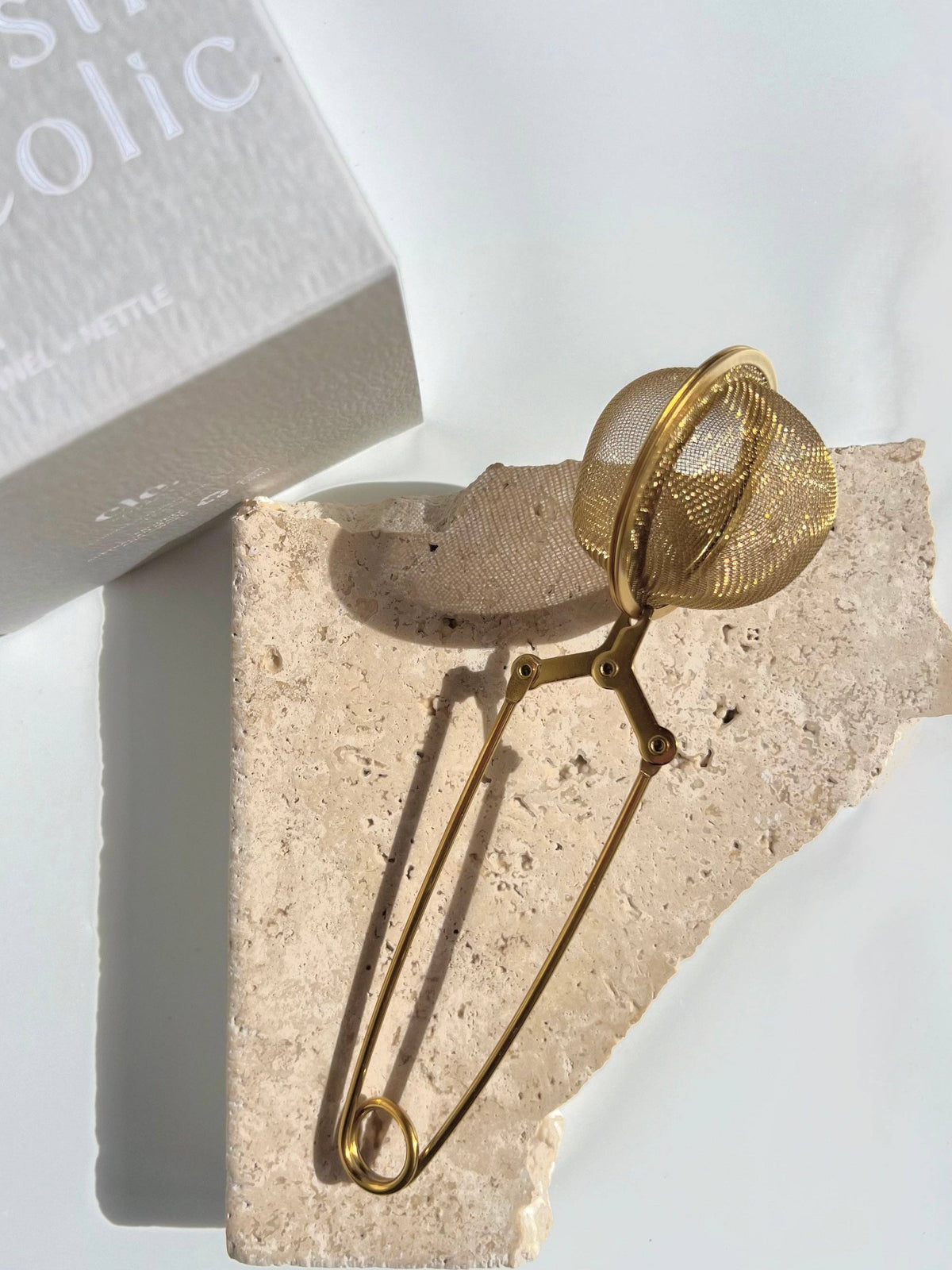 Gold mesh tea infuser.